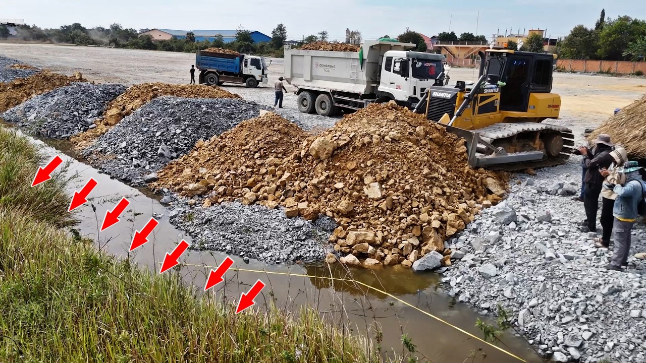 Powerful Land Transforming Process Bulldozer Pushing Stone & Soil Into Water, Dump Trucks Unloading
