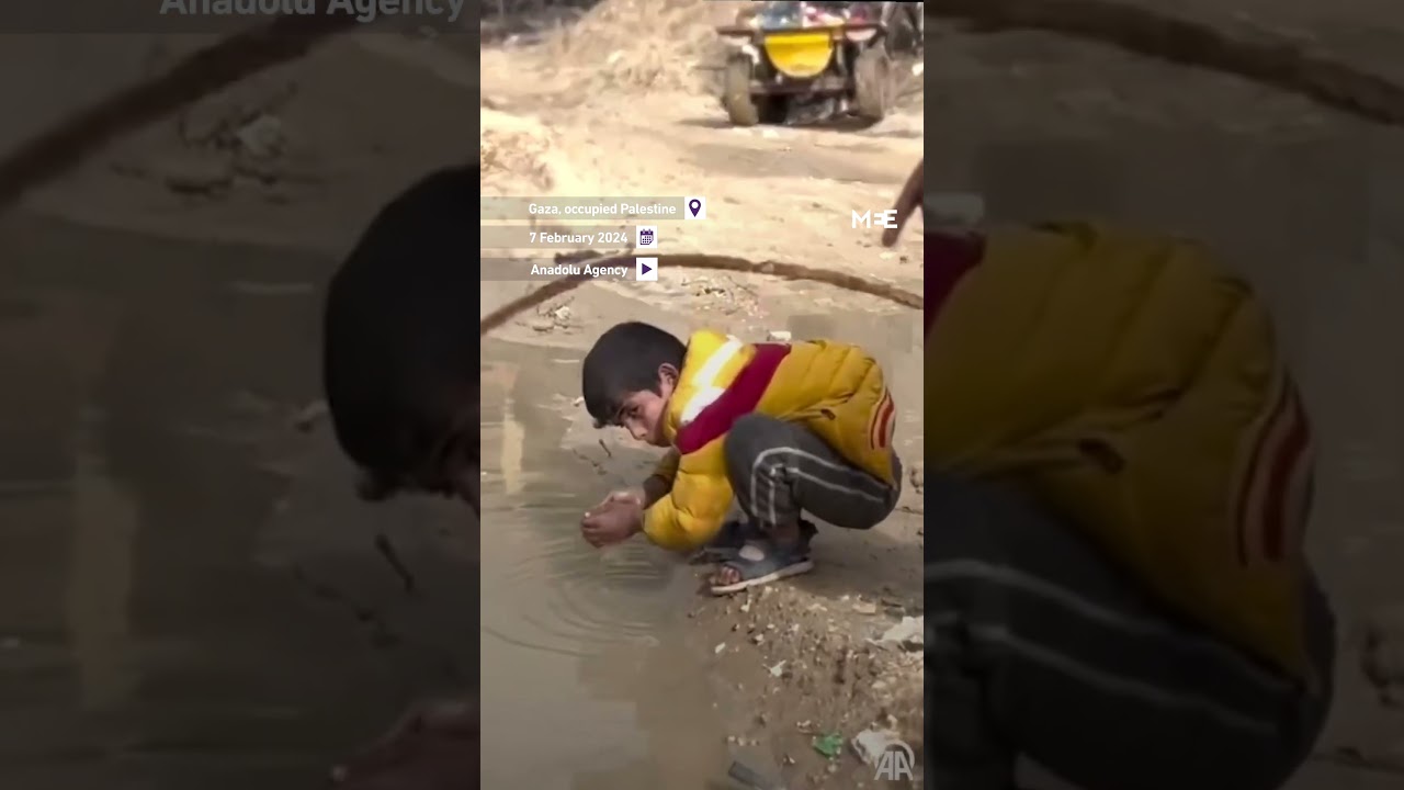 A child drinks from muddy water due to lack of clean water in Gaza