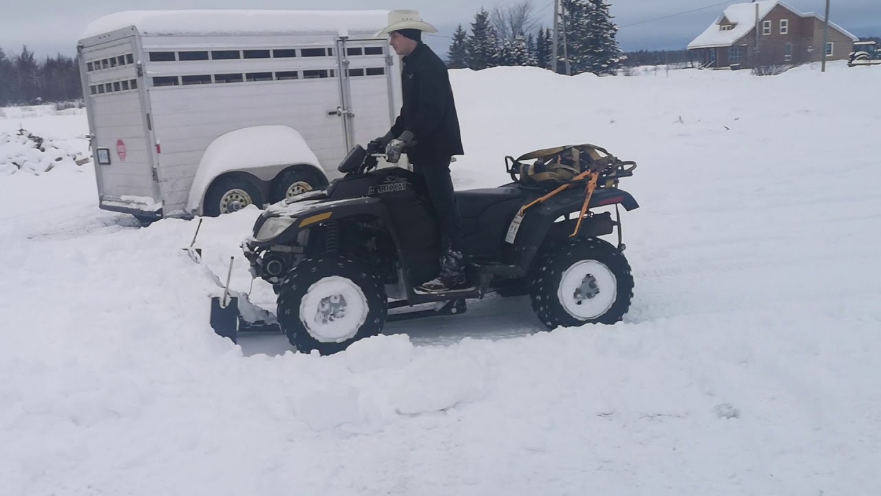 Arctic cat 700 diesel plowing heavy snow.