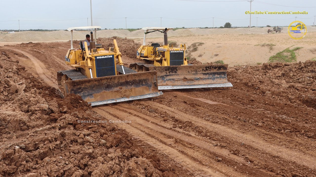 Komatsu D50P Bulldozers Pushing And Spreading Soil In The Field Site