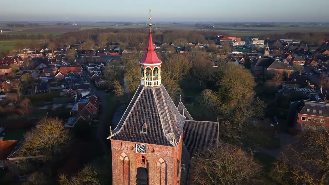 Middelstum windmill and church closeup round.