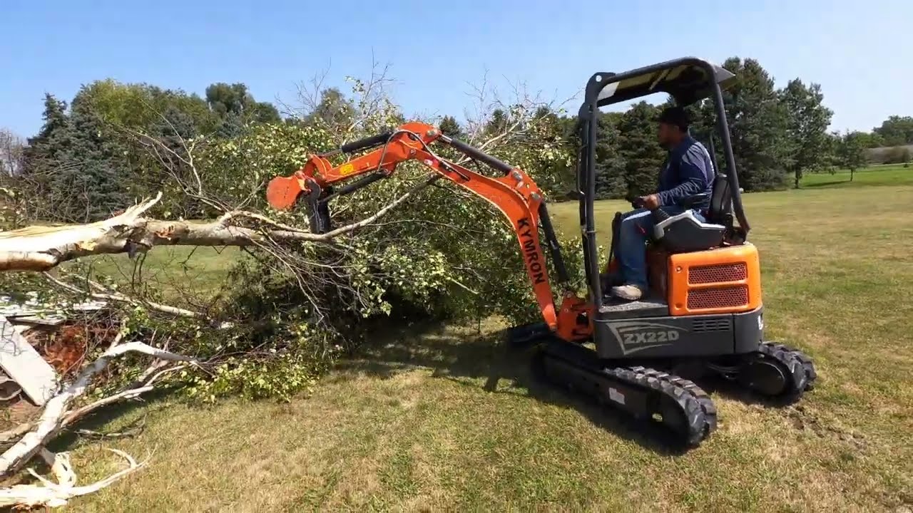 Chinese excavator rips out a tree and a wall!