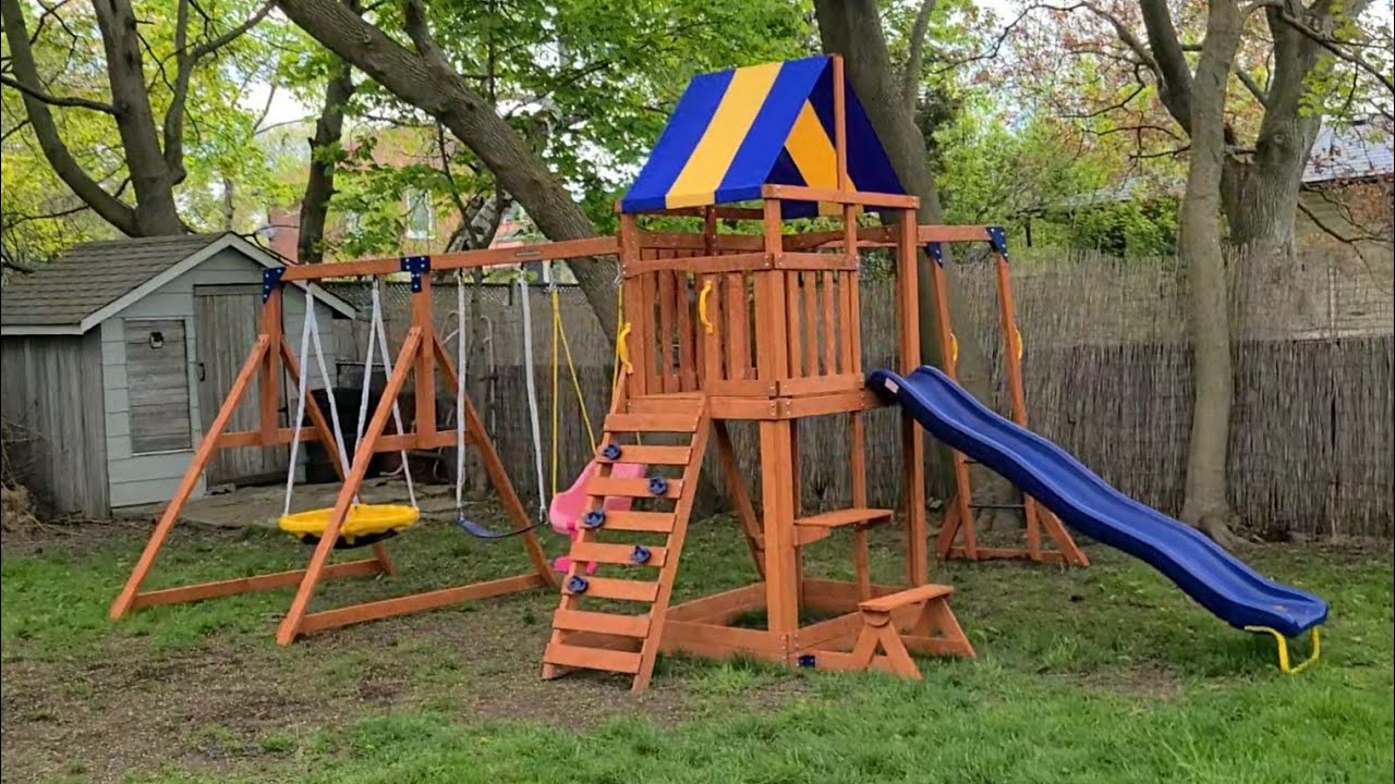 Assembling a Wooden Kids Playground with a slide & swingset