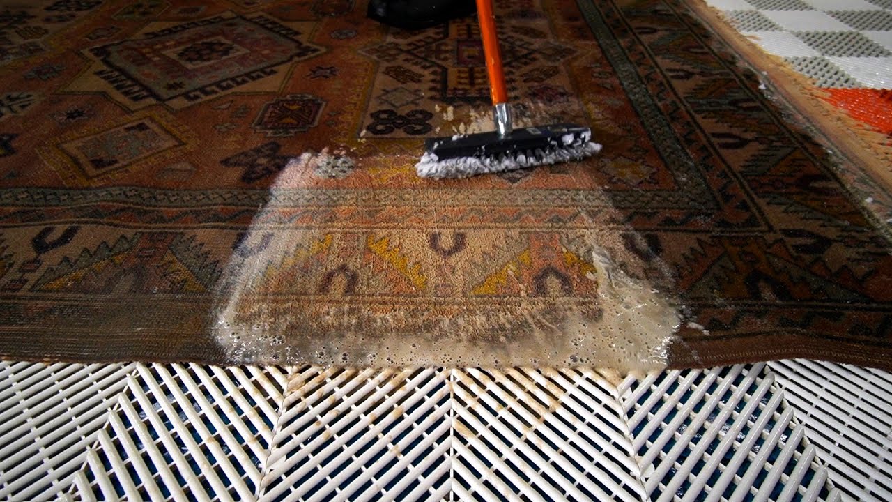 I used a brush to scrub through the thick layer of dirt in this rug