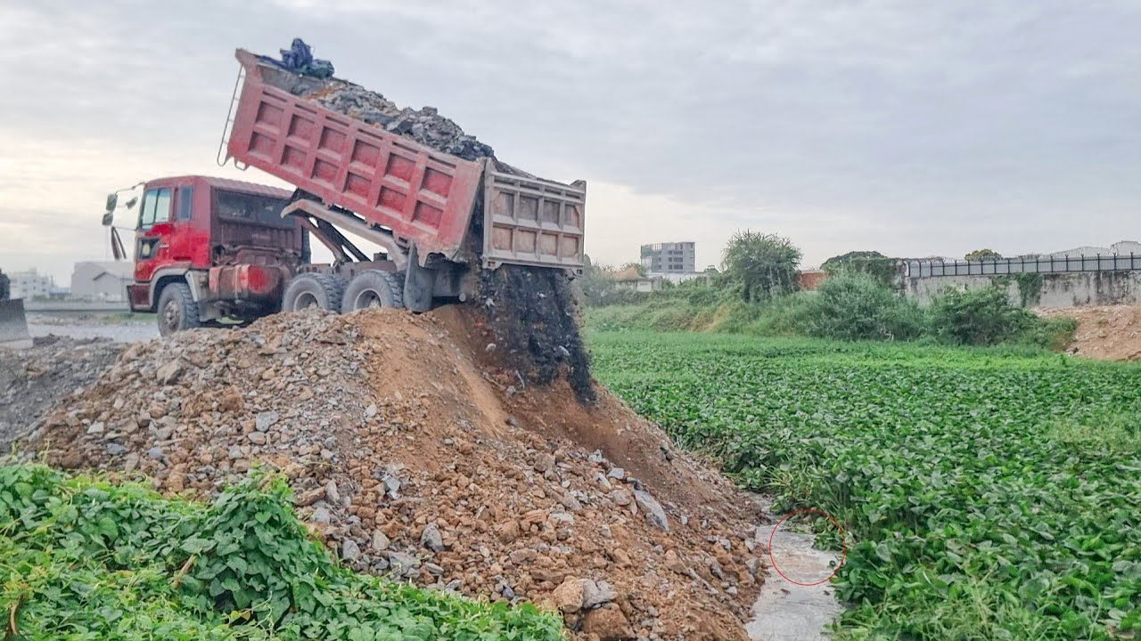 Start process build new road cross canal use rock smoothly work by Komatsu d41 pushing&12wheel truck