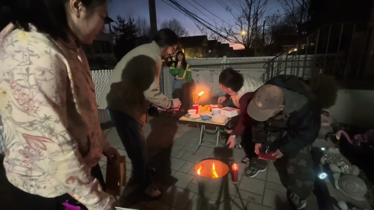 Praying And Burning Joss Paper With Family