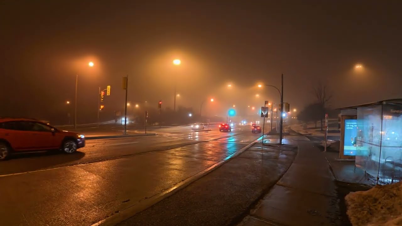 Enjoying the beauty of the foggy city at night under the lights.