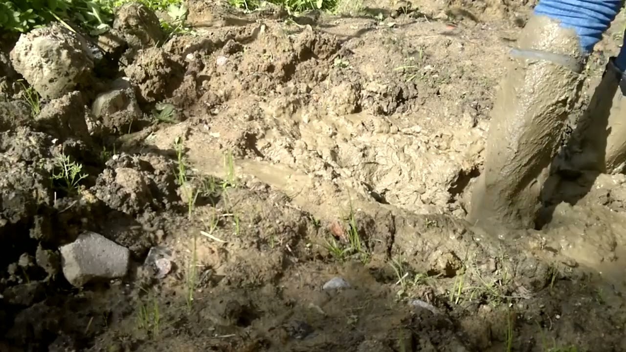 girl with rubber boots with high heels and jeans in the mud