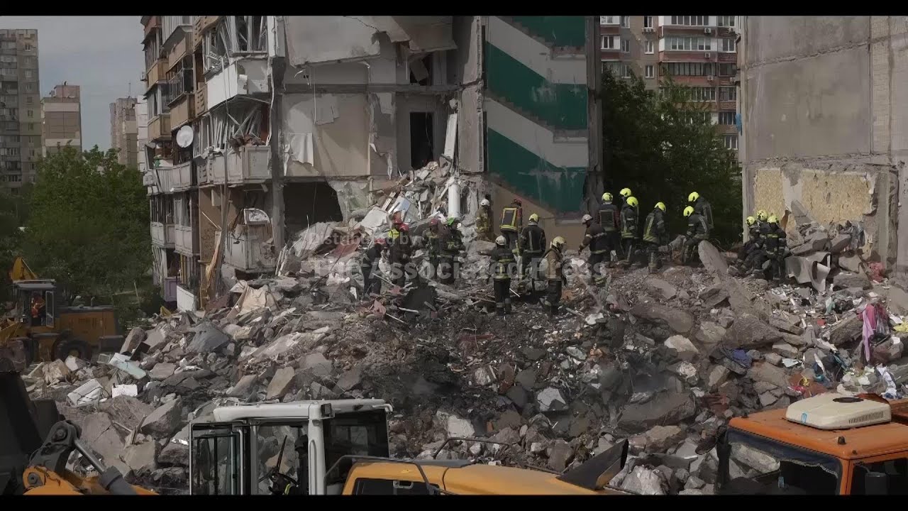 Rescuers search rubble of destroyed building after Russian attack flattens a Kyiv apartment block