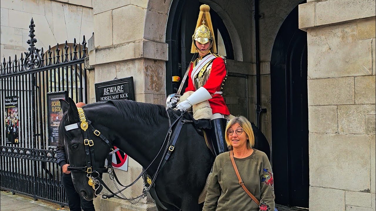 SNOOZY TOURIST GETS THE ROYAL BOOT AFTER IGNORING TWO COMMANDS FROM THE GUARD at Horse Guards!