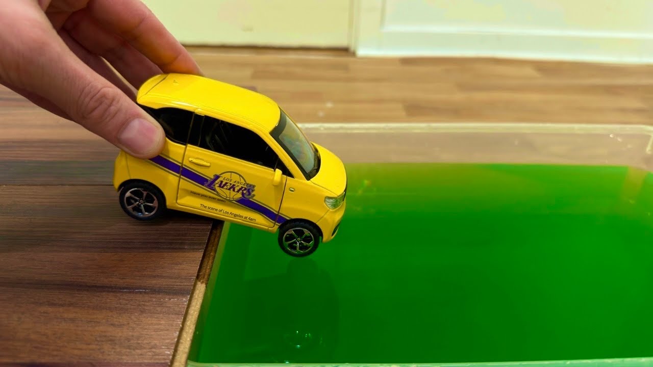 Diecast Cars Sliding Into The Green Water 
