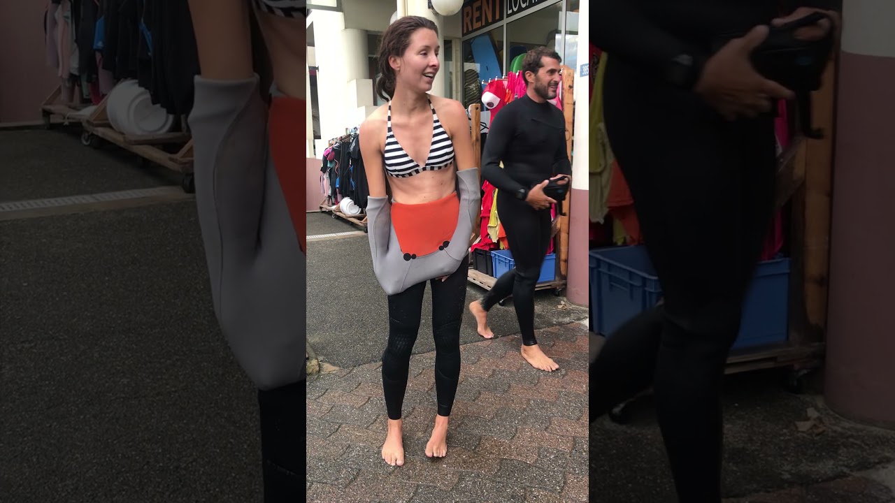 Beginner surfer taking wetsuit off in 2018