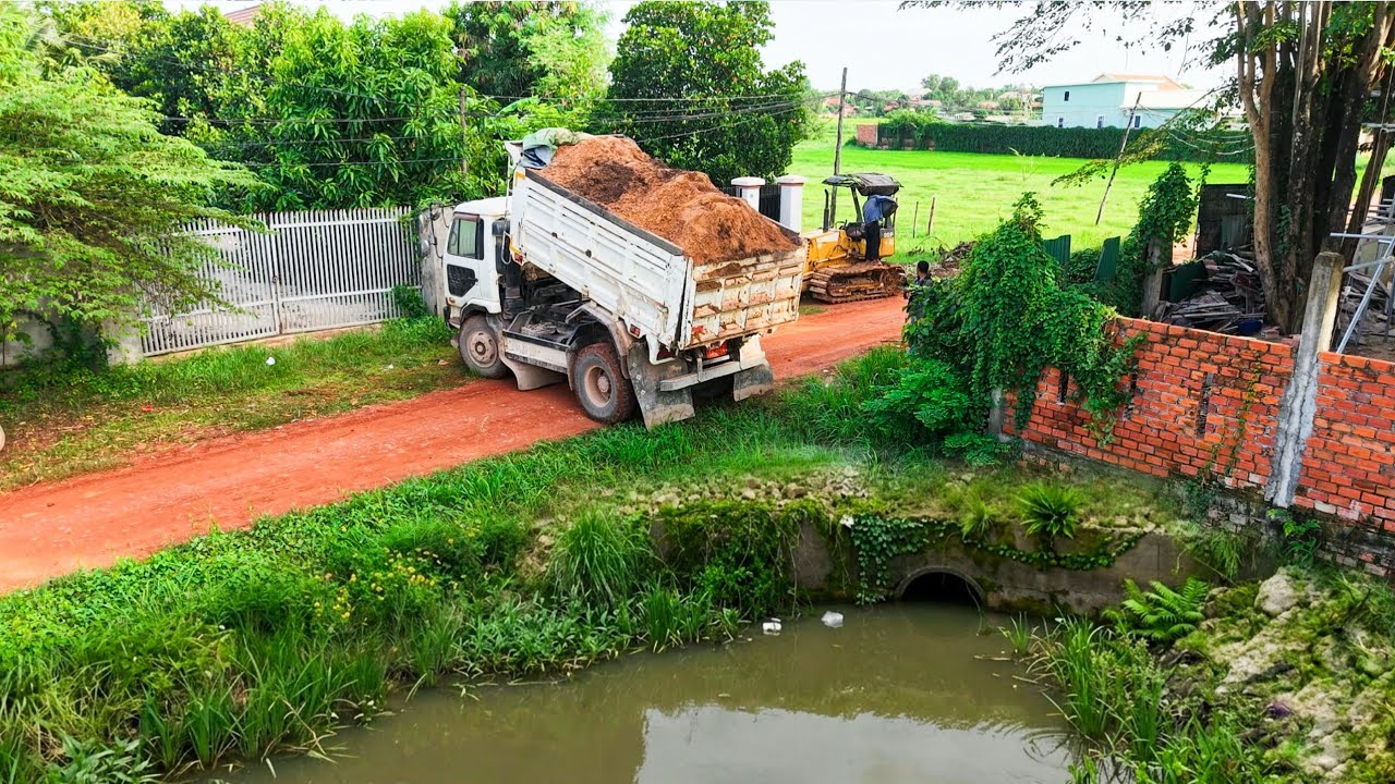 First Start Dump Truck Dumping Soil Landfill by skill drive dozer pushing with Nissan 5ton trucks 