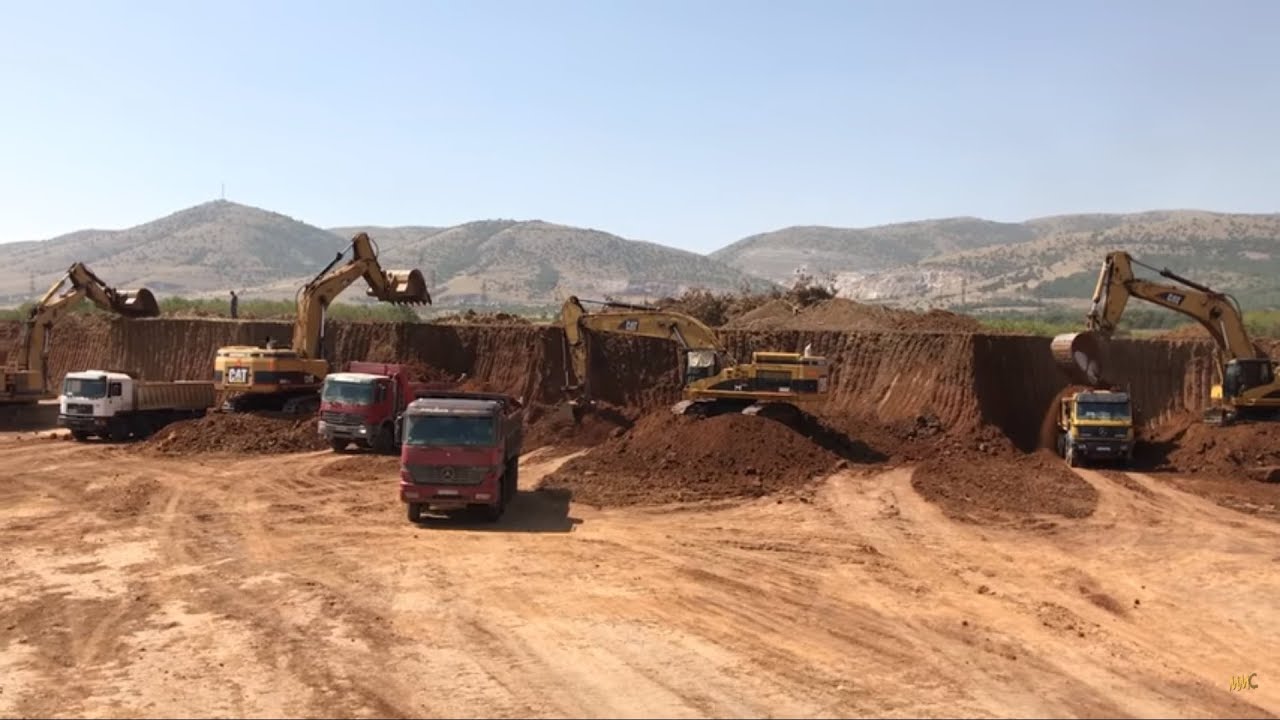 Three Caterpillar 365C Excavators And One Caterpillar 245 Loading Trucks