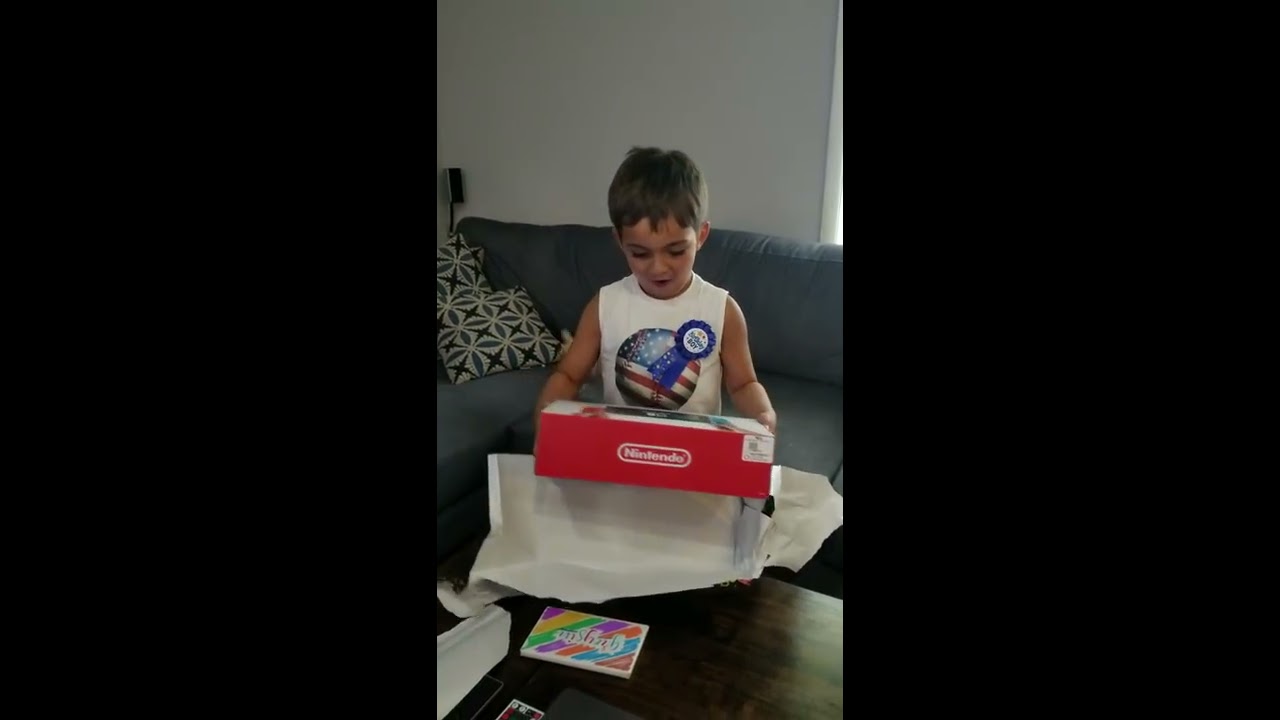 Kid unwraps Nintendo Switch for his birthday