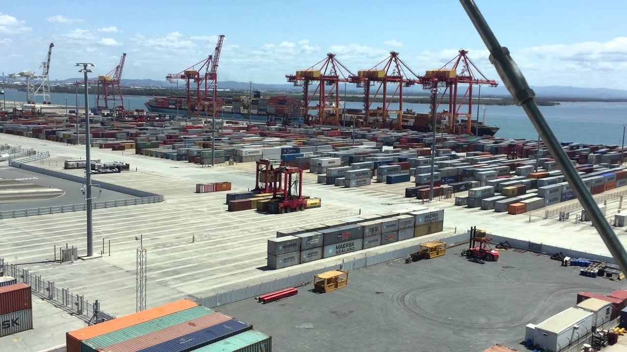 Robots and humans moving shipping containers at the Port of Brisbane