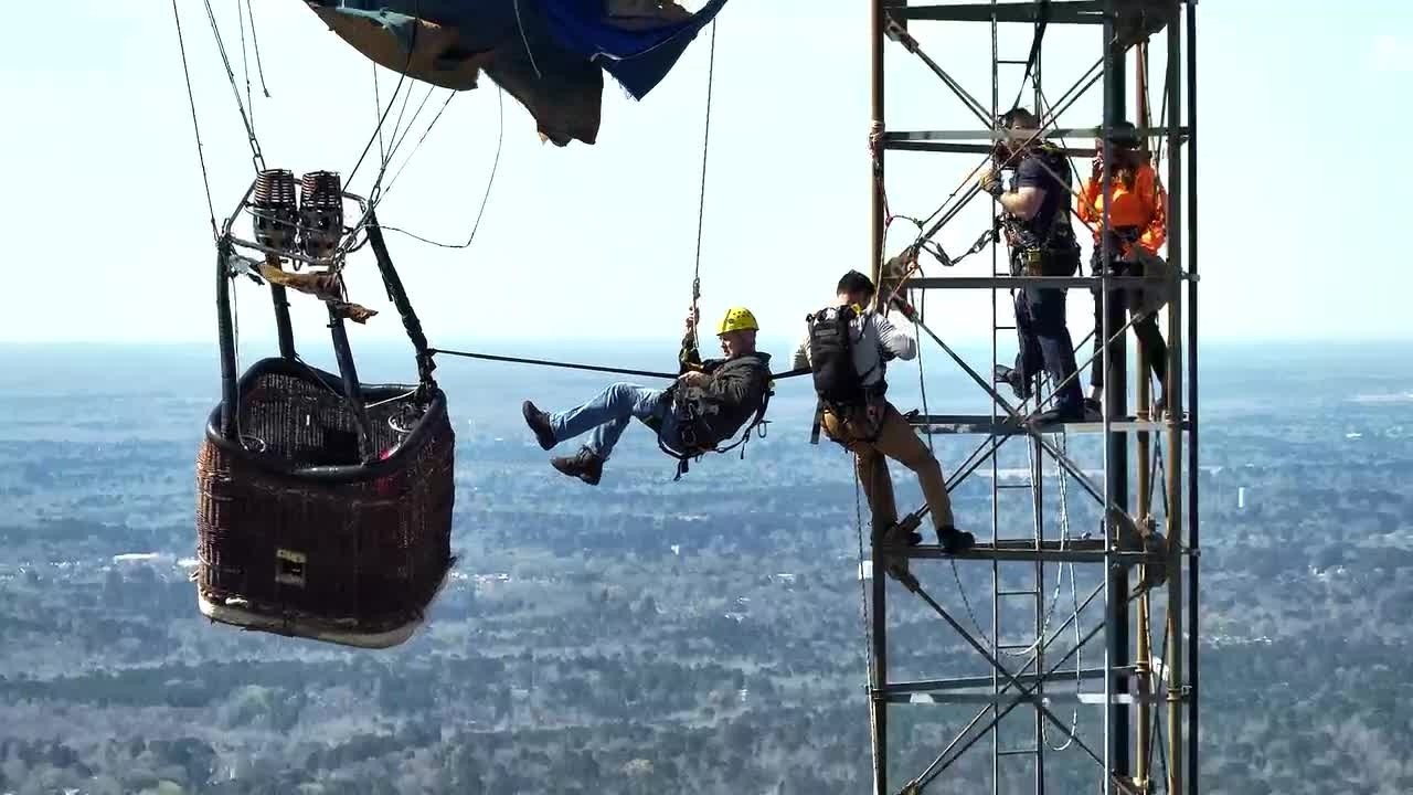 'Their courage to climb out of the basket' Firefighters describe rescuing 2 from balloon at 925 feet