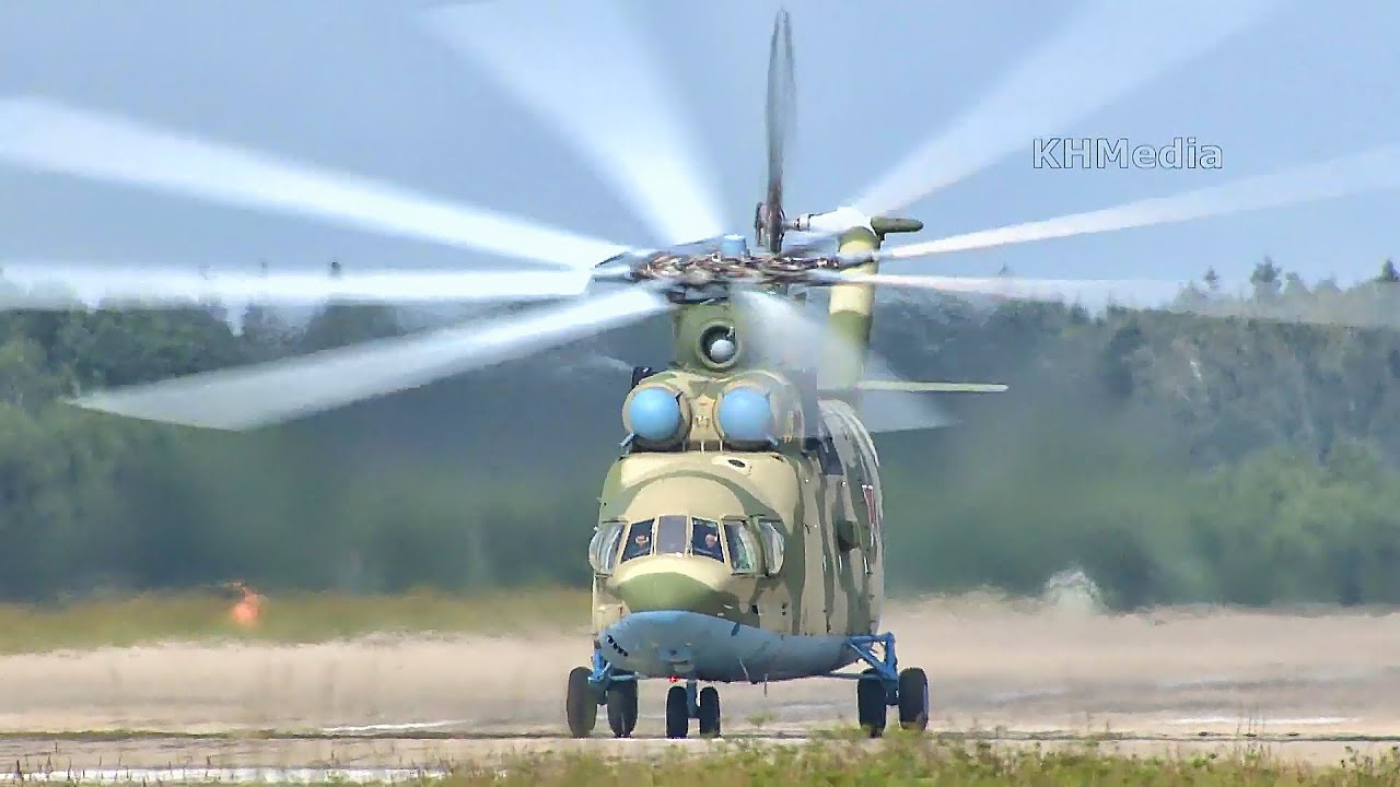 Huge Mil Mi-26 helicopter during takeoff, then pilot waves for a greeting
