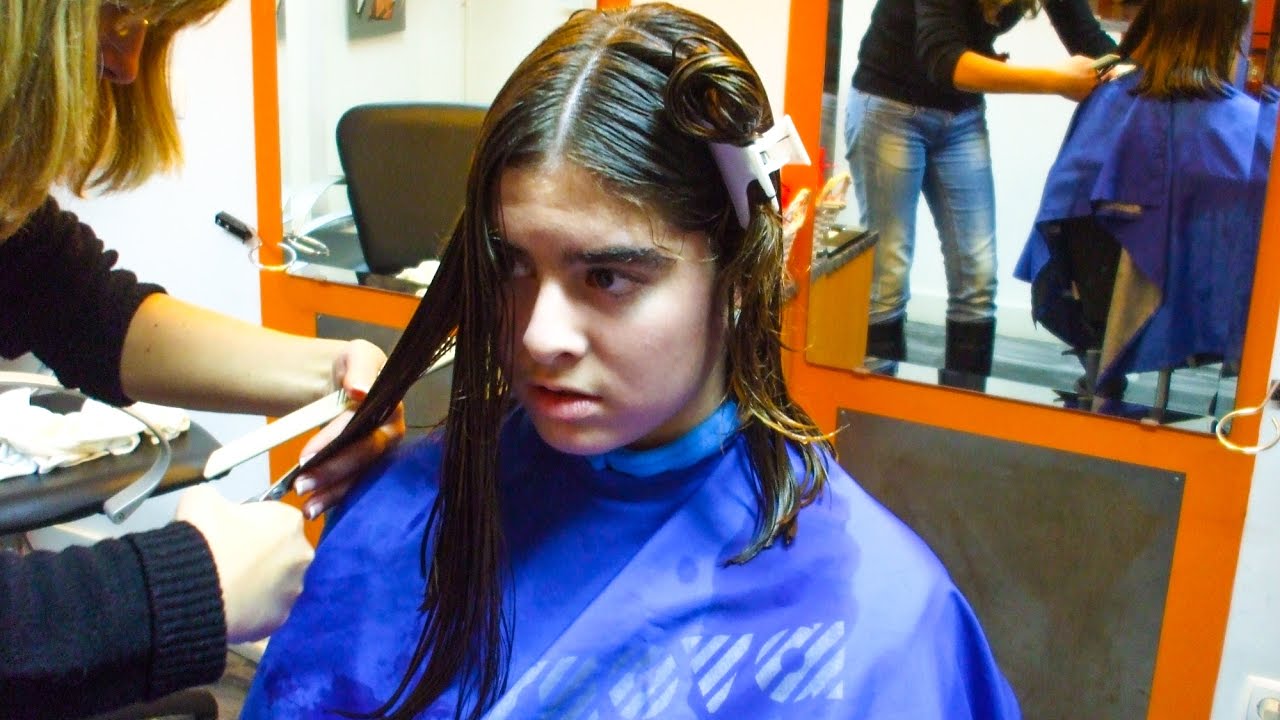 A gentle teenager changing her long hair for an inverted bob