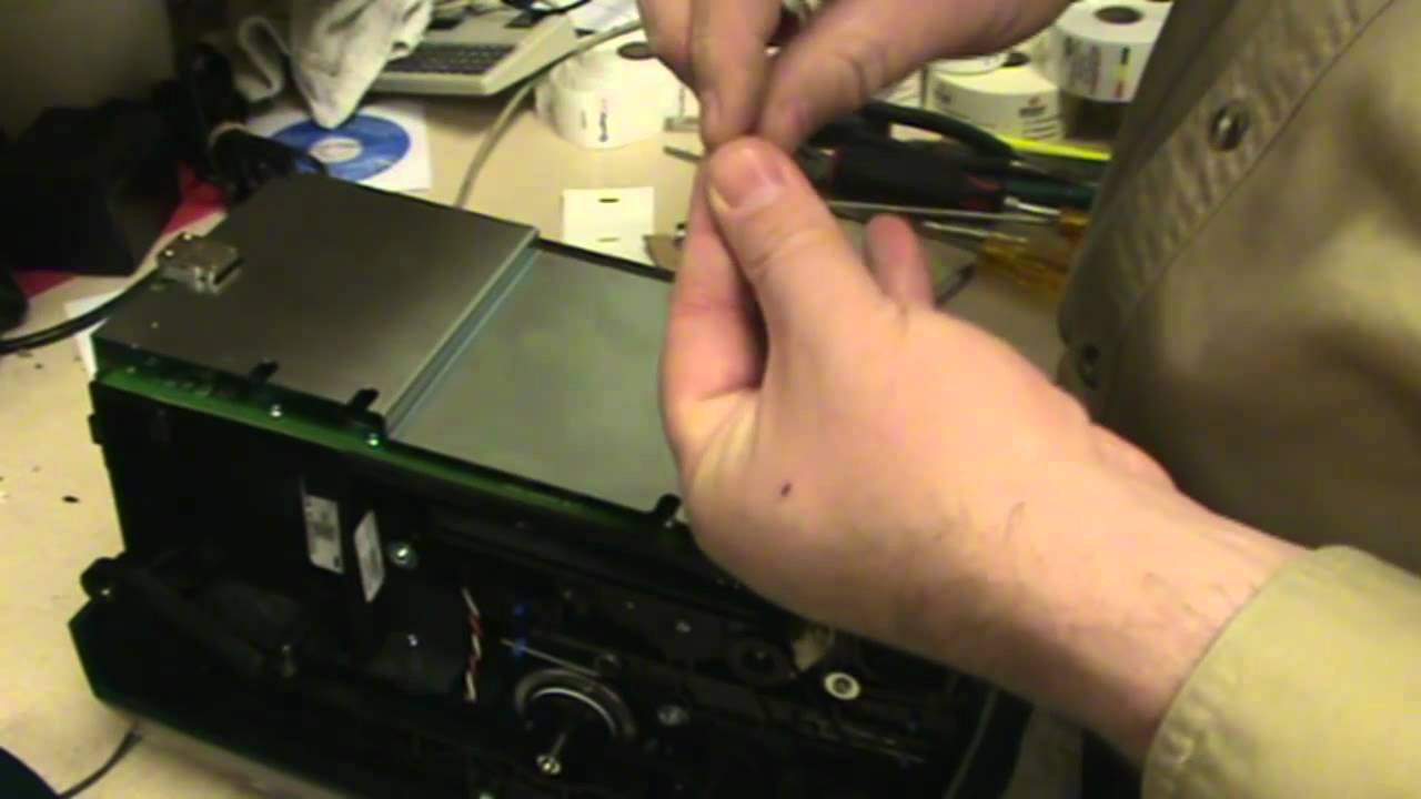 Reseating the network card on a p100i card printer