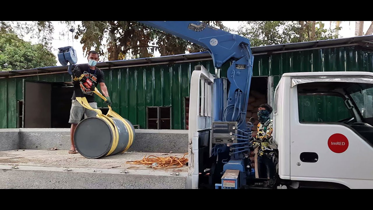 Isuzu Elf Boom Truck with Tadano ZR 263 Crane Unloading Drums of Engine Oil