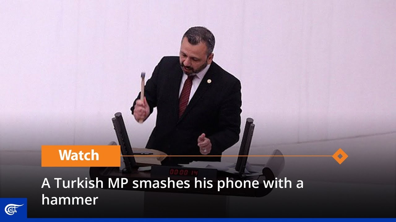 A Turkish MP smashes his phone with a hammer