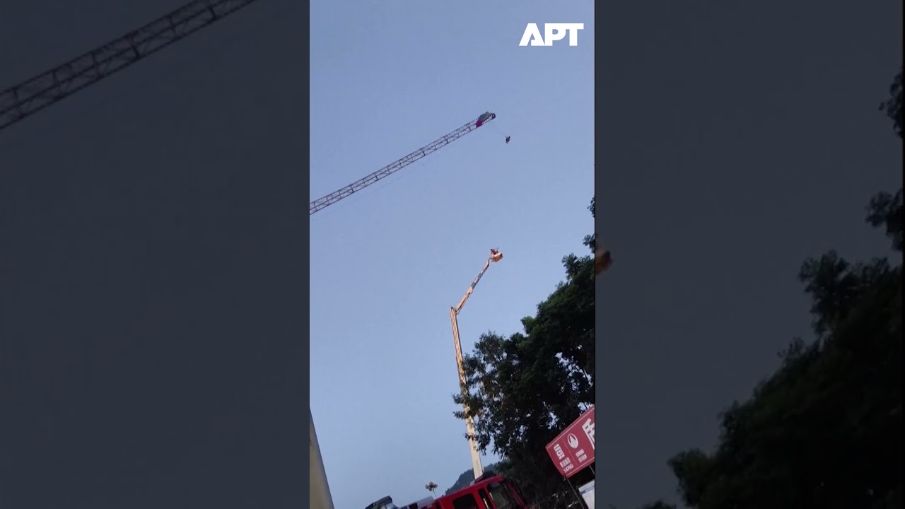Paraglider Stuck Midair On Tower Crane In China's Sichuan Province | APT