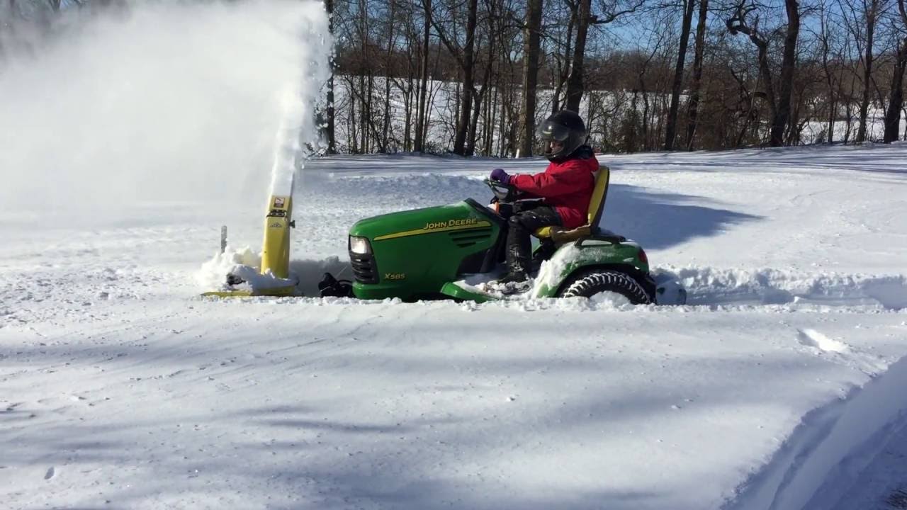 John Deere X585 blowing snow