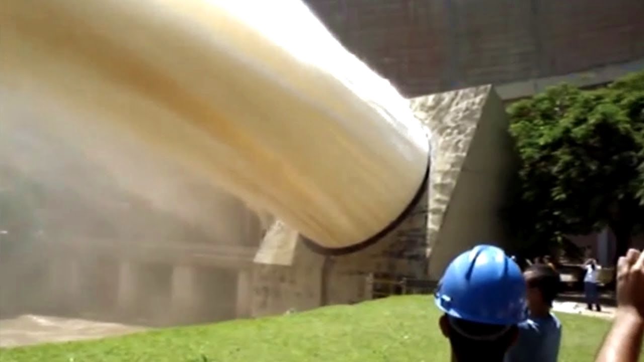 Technology construction hydroelectric, Big construction machine work, Giant water flow below the dam