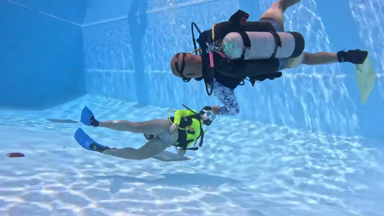 Female Scuba Diver training in pool with instructor