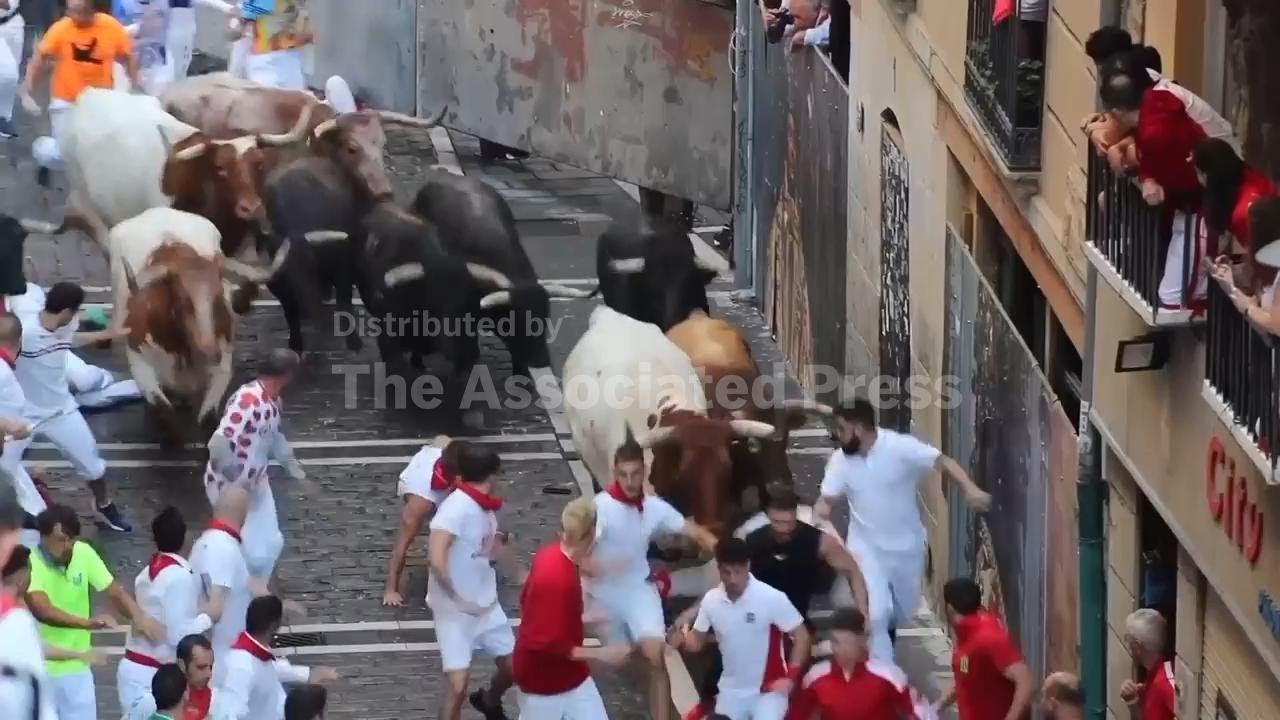 Spectators watch people running with bulls at the San Fermín festival