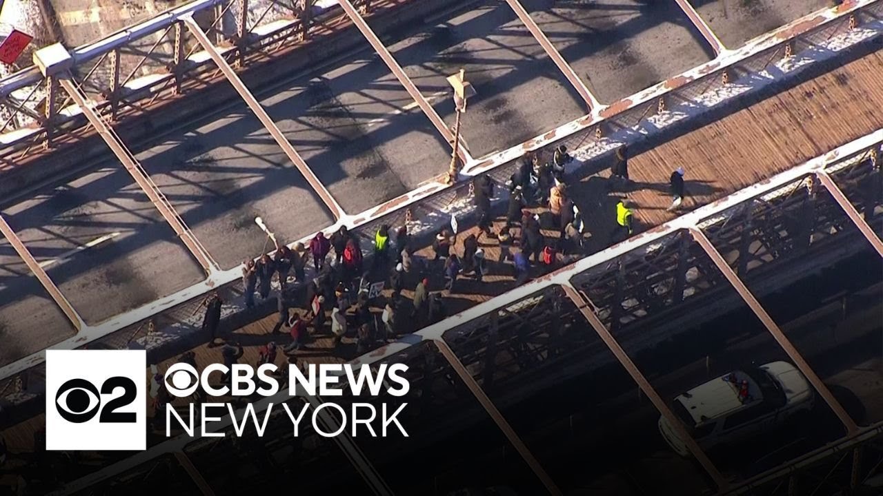 Anti-ICE protesters march across Brooklyn Bridge on MLK Day
