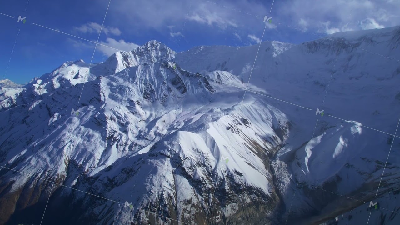 Descending aerial view Himalaya mountains range with snowy peaks in calm weather. Majestic