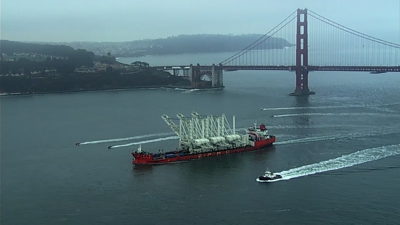 Massive Port of Oakland ship cranes transported under Golden Gate Bridge