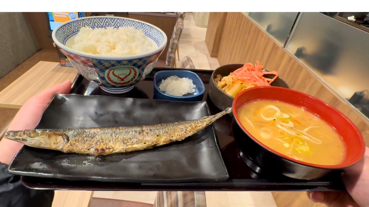 A Japanese nurse eating a grilled fish set meal for dinner