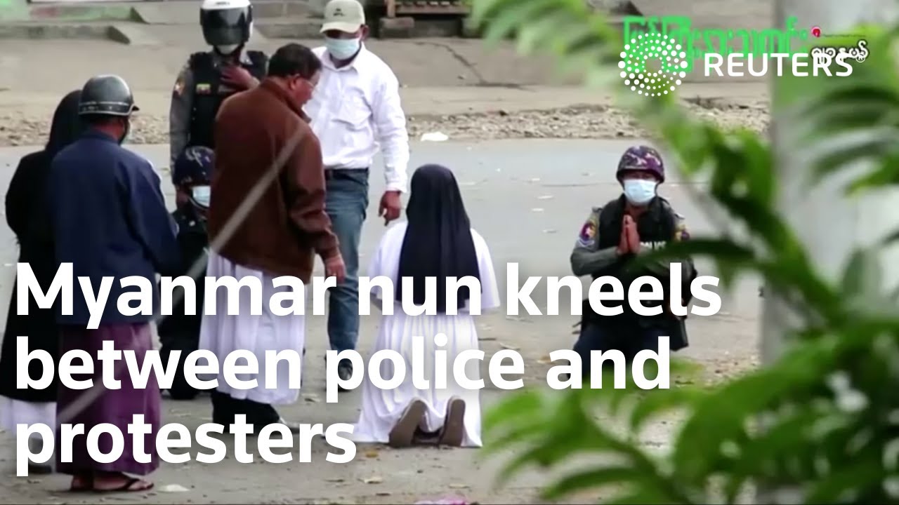 Myanmar nun kneels between police and protesters