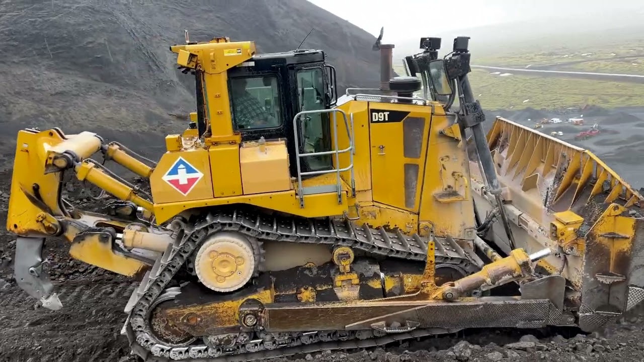 Cat D9T Pushing over Quarry Highwall