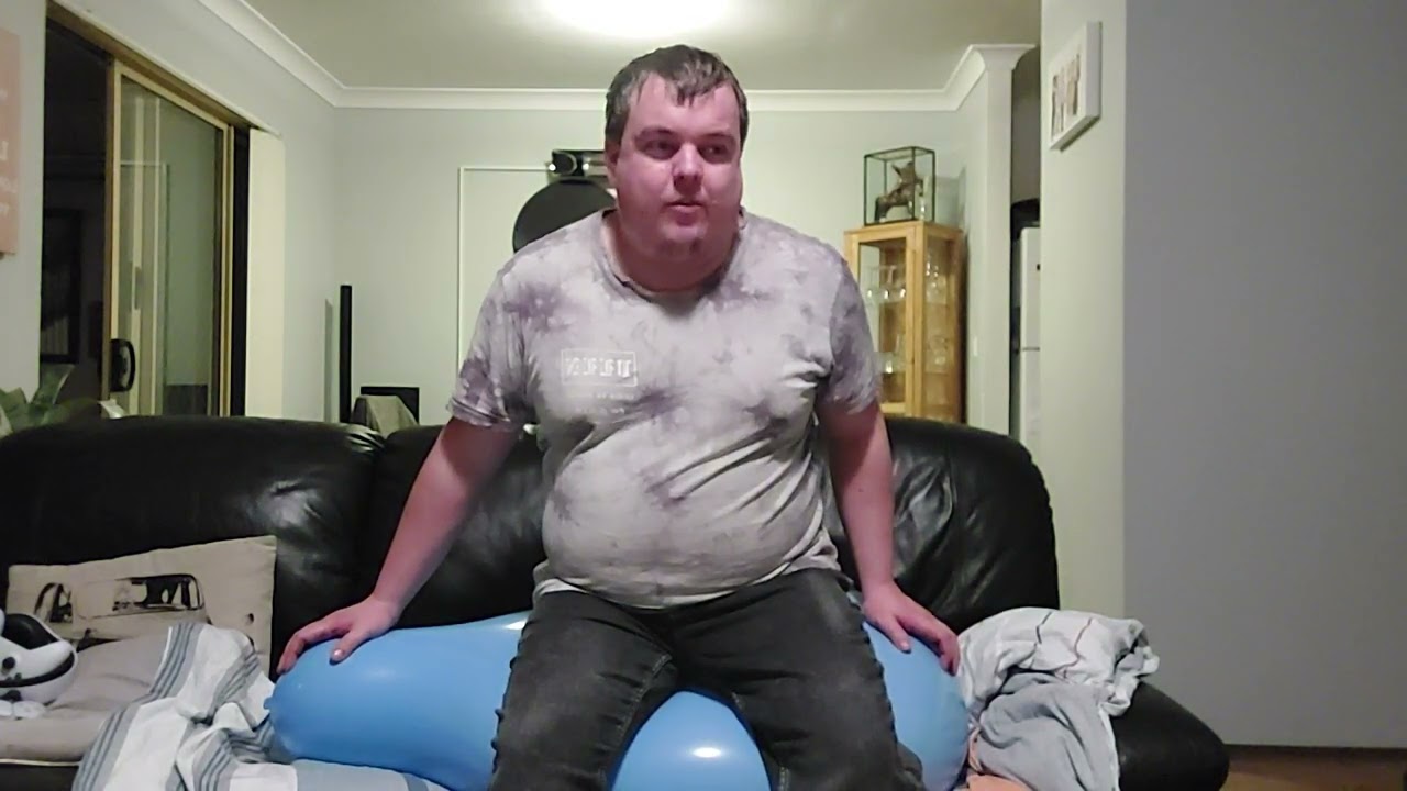 sitting on a blue 24 inch qualatex balloon