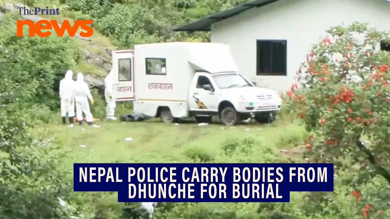 Nepal Police and rescue team carry bodies from Dhunche for burial