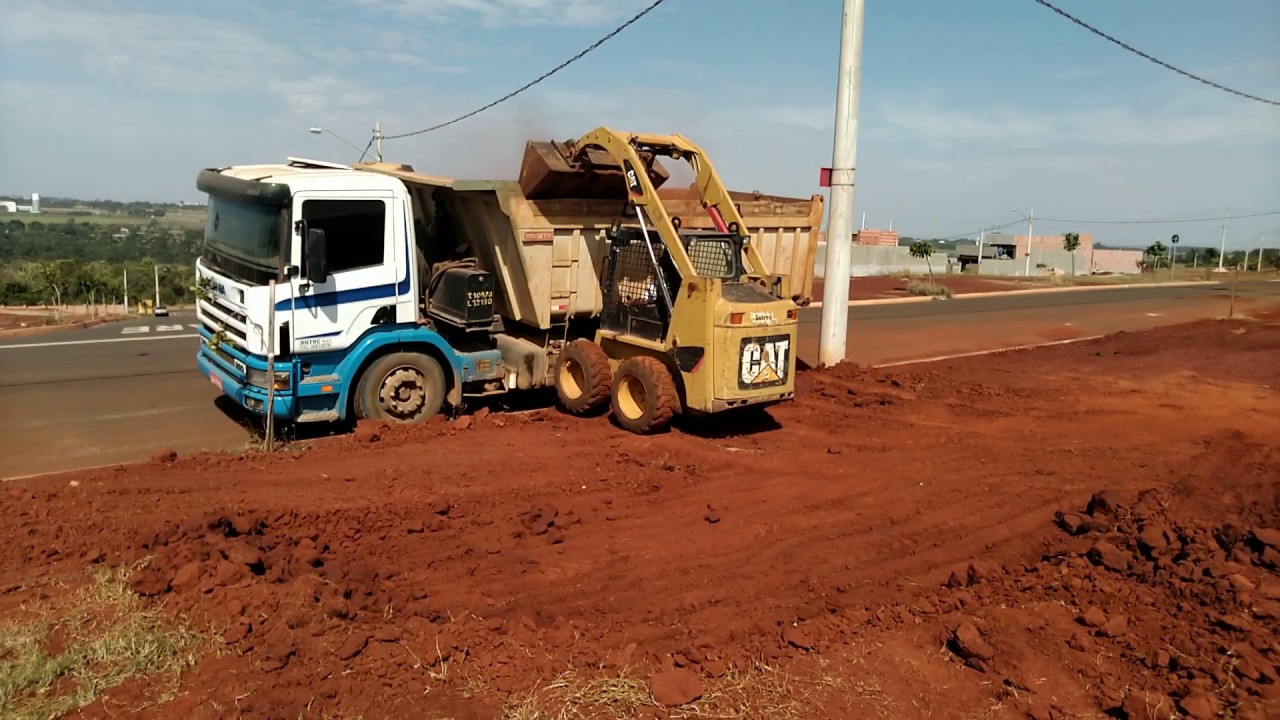 Mini carregadeira catterpillar 226 b com pente na turbina cortando terra
