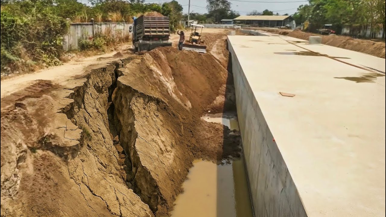 Small 5T Dump Trucks loading Sand Filling Large Drain With Small Bulldozer
