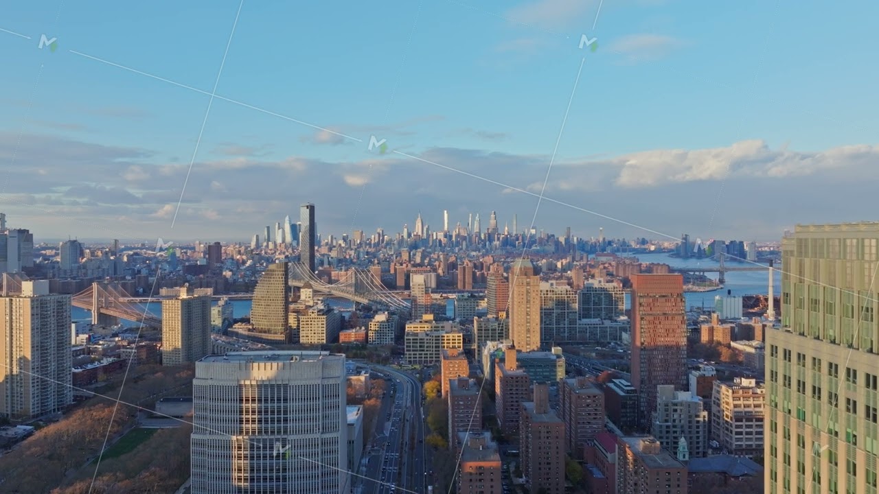 Aerial view of Downtown Brooklyn skyline and East River, featuring bridges, skyscrapers, and urban