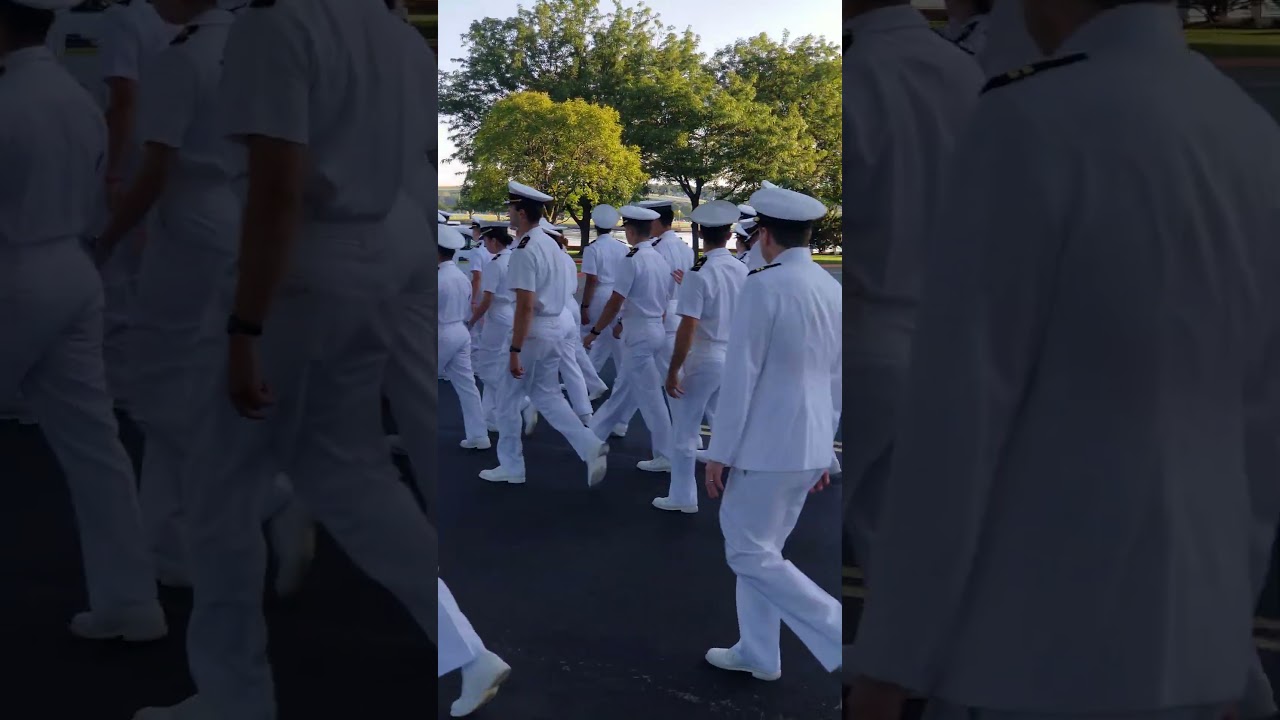 Midshipmen walking towards Class of 2023 Commissioning and Graduation