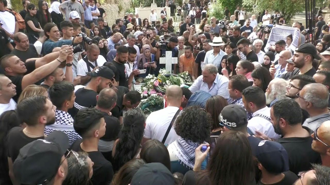 People gather at Mt Zion cemetery where slain Al Jazeera journalist is laid to rest | AFP