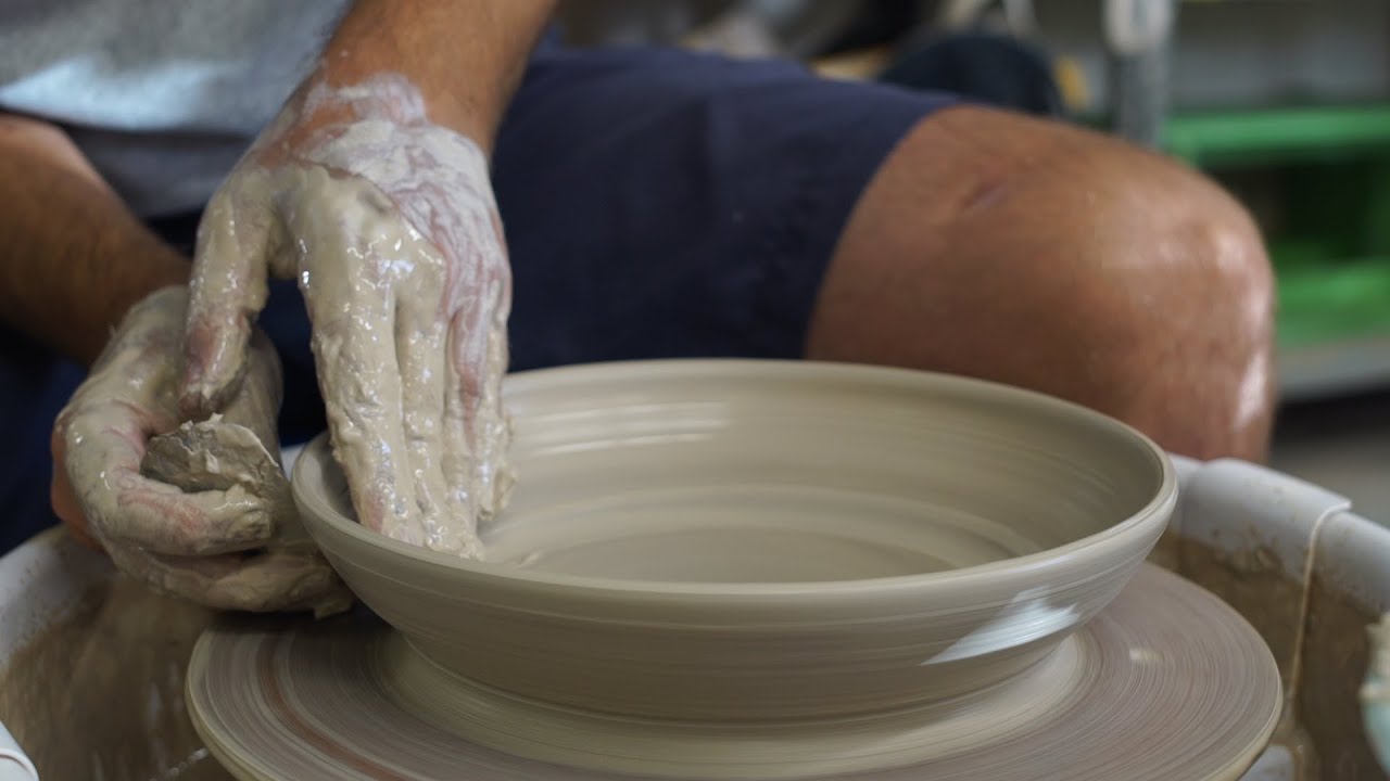 Throwing a shallow bowl on the pottery wheel