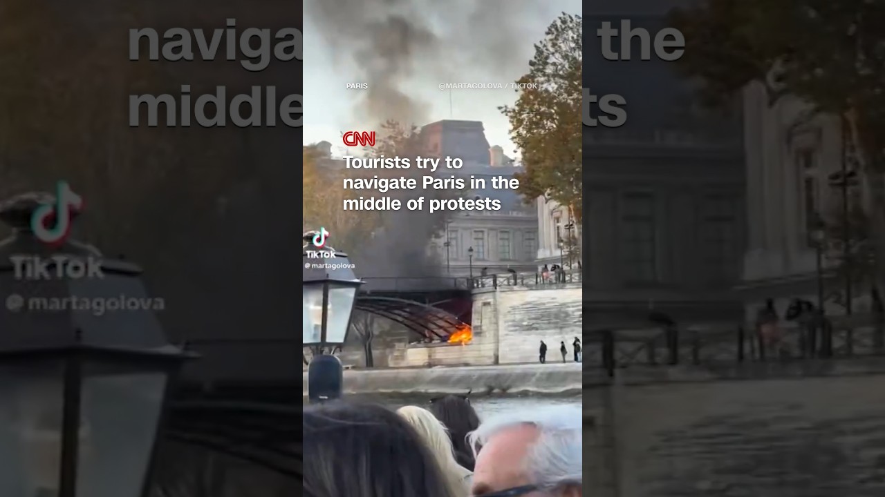 Tourists try to navigate Paris in the middle of protests