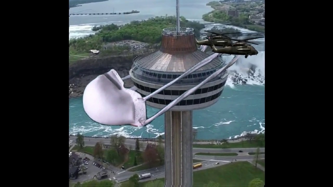 Helicopters Installing A Protective Mask On The Skylon Tower!
