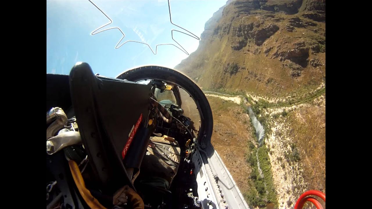 Buccaneer flying through the mountain valleys just a few feet from valley floor and mountain sides