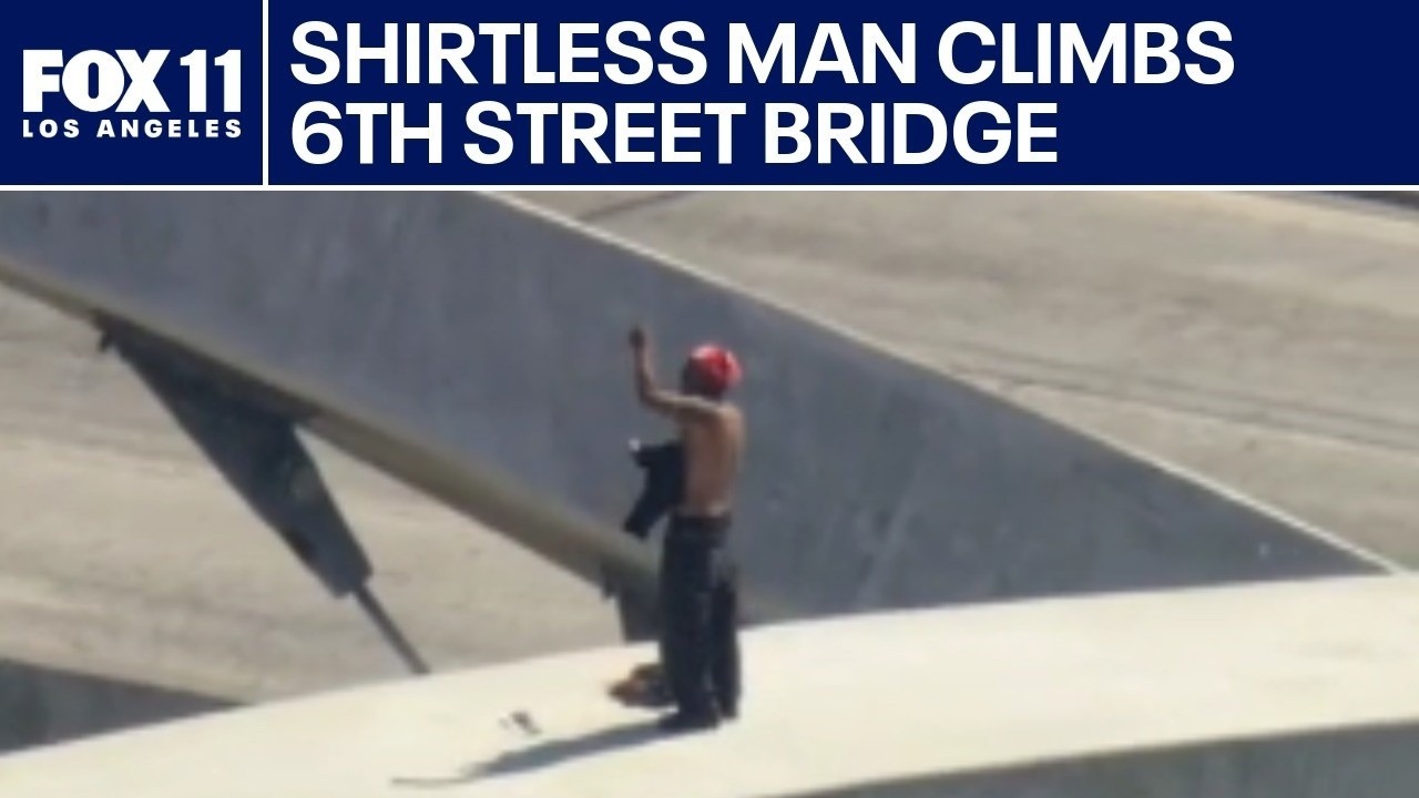 LIVE: Shirtless man climbs 6th Street Bridge in downtown LA
