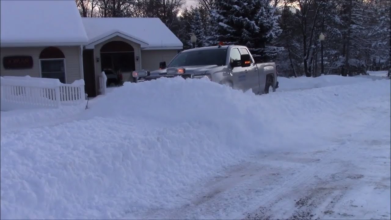 Plowing a foot of snow in a parking lot